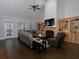 Spacious living room with vaulted ceiling, hardwood floors, built-in shelving, and a cozy fireplace at 5900 Fords Nw Rd, Acworth, GA 30101