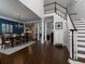 Open-concept living space with hardwood floors, staircase, columns, and views to dining room and kitchen at 5900 Fords Nw Rd, Acworth, GA 30101