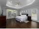 Spacious main bedroom features a tray ceiling, hardwood floors, and large windows at 5900 Fords Nw Rd, Acworth, GA 30101