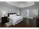 Relaxing main bedroom features a tray ceiling, hardwood floors, and ample natural light at 5900 Fords Nw Rd, Acworth, GA 30101