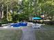 Backyard features a sparkling pool with lounge chairs and an umbrella for relaxing at 5900 Fords Nw Rd, Acworth, GA 30101