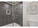 Modern tiled shower with built in seat, niche, and glass door, enhanced by decorative wall art at 1468 Briarwood Ne Rd # 703, Atlanta, GA 30319