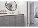 Chic bathroom vanity with marble countertop, ample storage, and contemporary round mirror at 1468 Briarwood Ne Rd # 703, Atlanta, GA 30319