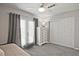 Bright bedroom with ceiling fan, double doors to balcony, and a spacious closet at 1468 Briarwood Ne Rd # 703, Atlanta, GA 30319