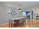 Cozy dining area featuring hardwood floors, modern lighting fixture, and a decorative accent wall at 1468 Briarwood Ne Rd # 703, Atlanta, GA 30319