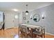 Bright dining area with natural light, modern light fixtures, hardwood floors and textured accent wall at 1468 Briarwood Ne Rd # 703, Atlanta, GA 30319