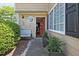 Welcoming entrance to a lovely home with a charming octagonal window, stylish bench, and decorative potted plants at 1468 Briarwood Ne Rd # 703, Atlanta, GA 30319