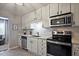Updated kitchen featuring stainless steel appliances, white cabinetry, and modern countertops at 1468 Briarwood Ne Rd # 703, Atlanta, GA 30319