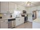 Clean kitchen featuring white cabinets, stainless steel appliances and solid surface countertops at 1468 Briarwood Ne Rd # 703, Atlanta, GA 30319