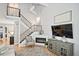 Well-lit living room showcasing a modern fireplace, staircase, TV, and stylish decor, creating a welcoming ambiance at 1468 Briarwood Ne Rd # 703, Atlanta, GA 30319