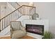 Elegant living room featuring a contemporary fireplace, staircase with a wooden railing, and hardwood floors at 1468 Briarwood Ne Rd # 703, Atlanta, GA 30319