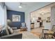 Comfortable living room with an adjacent white cabinet kitchen featuring stainless steel appliances at 1468 Briarwood Ne Rd # 703, Atlanta, GA 30319