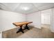 Spacious unfinished basement featuring carpeted floors, a large wooden table, and a doorway to another room at 2784 Sixes Rd, Canton, GA 30114