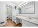 Bathroom featuring double sinks, wood-look flooring, a toilet, and ample counter space with under-counter storage at 2784 Sixes Rd, Canton, GA 30114
