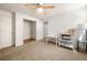 Sunlit bedroom with carpet floors, a ceiling fan, neutral walls, desk, and natural light through a bright window at 2784 Sixes Rd, Canton, GA 30114