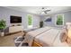 Spacious main bedroom with plush carpeting, modern ceiling fan, and abundant natural light at 2784 Sixes Rd, Canton, GA 30114
