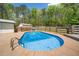 Backyard with an inground pool and ladder, enclosed by a wooden fence with trees at 2784 Sixes Rd, Canton, GA 30114
