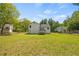 Wide shot of backyard with a deck and a view of trees at 2990 Williams Farm Dr, Dacula, GA 30019