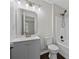 Bathroom featuring a single sink vanity with gray cabinets, a toilet, and a shower-tub combo at 2990 Williams Farm Dr, Dacula, GA 30019