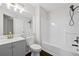Bathroom featuring a single sink vanity with gray cabinets, a toilet, and a shower-tub combo at 2990 Williams Farm Dr, Dacula, GA 30019
