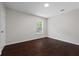 Bedroom with hardwood floors, a window, and neutral paint throughout at 2990 Williams Farm Dr, Dacula, GA 30019