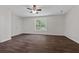 Large bedroom featuring hardwood floors, a ceiling fan, neutral paint, and a window at 2990 Williams Farm Dr, Dacula, GA 30019