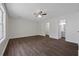 Spacious bedroom with hardwood floors, neutral paint, a ceiling fan, and a double door closet at 2990 Williams Farm Dr, Dacula, GA 30019
