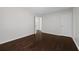 Bedroom featuring hardwood floors, neutral paint, and two doors at 2990 Williams Farm Dr, Dacula, GA 30019