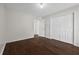 Bedroom featuring double closet, neutral paint, and wood floors at 2990 Williams Farm Dr, Dacula, GA 30019