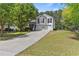 Charming two-story home with a manicured lawn, double garage, and inviting curb appeal surrounded by lush trees at 2990 Williams Farm Dr, Dacula, GA 30019