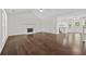 Open-concept living room boasting hardwood floors and a fireplace, perfect for entertaining at 2990 Williams Farm Dr, Dacula, GA 30019