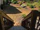 Landscaped backyard with retaining wall and stairs to wooded lower area at 5679 Coopers Glen Ct, Mableton, GA 30126