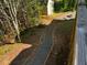Well maintained backyard with shed, firepit, and gravel pathway at 5679 Coopers Glen Ct, Mableton, GA 30126