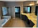 Bright bathroom featuring a soaking tub, glass-enclosed shower, and double vanity at 5679 Coopers Glen Ct, Mableton, GA 30126