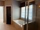 Bathroom with a soaking tub, a tiled floor, and enclosed glass shower at 5679 Coopers Glen Ct, Mableton, GA 30126
