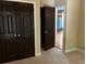 Bedroom with double closet doors and view to an adjacent room, featuring neutral carpet at 5679 Coopers Glen Ct, Mableton, GA 30126