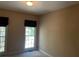 Standard bedroom with neutral carpet, large window, and a neutral paint color at 5679 Coopers Glen Ct, Mableton, GA 30126