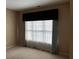 Bedroom featuring neutral walls, carpet floors, and window with blinds and curtains at 5679 Coopers Glen Ct, Mableton, GA 30126