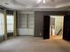 Spacious bedroom featuring soft carpet, neutral walls, custom built-ins, and natural light from the windows at 5679 Coopers Glen Ct, Mableton, GA 30126