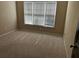 Cozy bedroom featuring a window with blinds and neutral carpeting at 5679 Coopers Glen Ct, Mableton, GA 30126