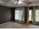 Bedroom featuring soft carpet, neutral walls, a ceiling fan, and natural light from the windows at 5679 Coopers Glen Ct, Mableton, GA 30126