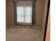 Bedroom with a window, patterned curtains, and neutral colored carpeting at 5679 Coopers Glen Ct, Mableton, GA 30126