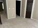 Bedroom with neutral walls and carpeting and contrasting dark doors at 5679 Coopers Glen Ct, Mableton, GA 30126
