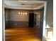 Elegant dining room with hardwood floors, wainscoting, modern chandelier, and adjoining access to kitchen at 5679 Coopers Glen Ct, Mableton, GA 30126