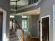 Spacious foyer featuring hardwood floors, an open staircase, and a view into the living room at 5679 Coopers Glen Ct, Mableton, GA 30126