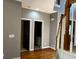First floor hallway with wood floors, staircase, and views to a half bathroom at 5679 Coopers Glen Ct, Mableton, GA 30126