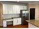 Bright kitchen featuring white cabinets, stainless steel appliances, granite countertops, and a built-in desk at 5679 Coopers Glen Ct, Mableton, GA 30126