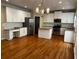 Spacious kitchen featuring white cabinets, stainless steel appliances, granite countertops, and hardwood floors at 5679 Coopers Glen Ct, Mableton, GA 30126
