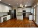 Bright kitchen featuring white cabinets, stainless steel appliances, granite countertops, and hardwood floors at 5679 Coopers Glen Ct, Mableton, GA 30126