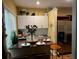 Bright kitchen with stainless steel appliances, white cabinets, and dining area at 5679 Coopers Glen Ct, Mableton, GA 30126